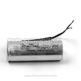 Side view of Silver metal capacitor 80/100uF with black cable for freezer