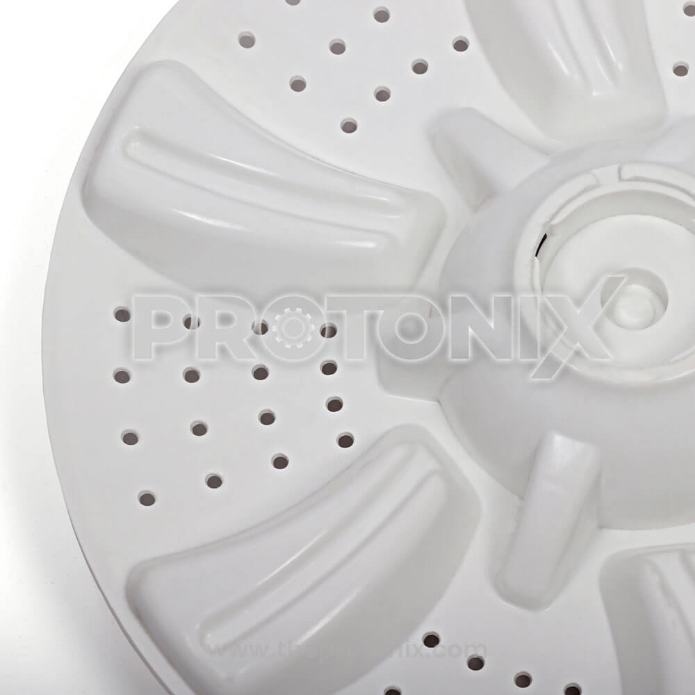 Close-up of Croma washing machine pulsator plate with cap and holes